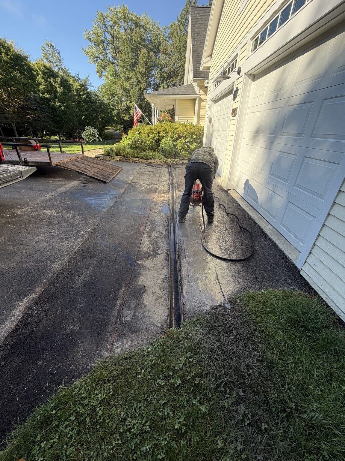 Drainage work beside a paved driveway